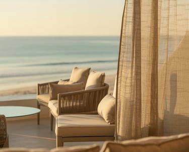 a couch with a table and chairs in front of a beach