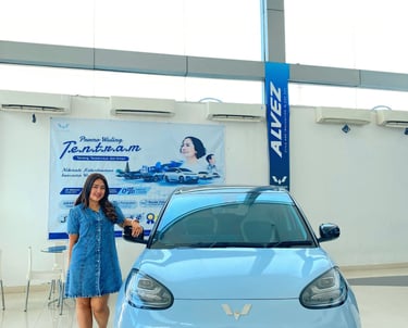a woman standing in front of a car