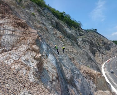 a group of people standing on a hill side road