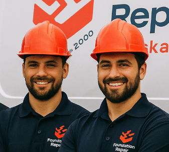 Team of Saskatoon foundation repair workers wearing matching uniforms and hats, standing together on