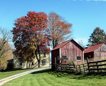 a red barn with a red barn in the background