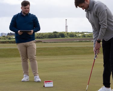 A golf coach in Aberdeen conducts a putting lesson using advanced technology and training aids to enhance putting skills