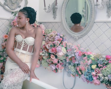 a woman in a white dress sitting on a bathtub