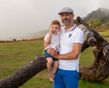 Parents smiling at toddler son during golden hour family portrait session at Fanal Forest Madeira