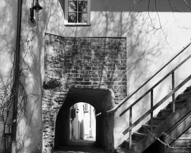 An aged brick building with an exterior stairway