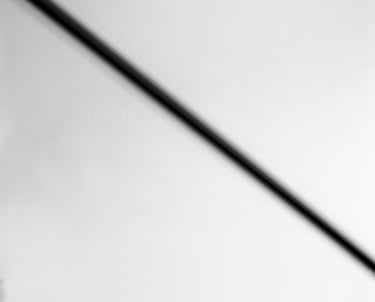 A monochrome image of a street sign, devoid of color, captured in black and white.