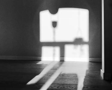Black and white photograph of window shadow on the wall