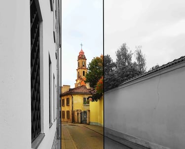 Narrow street picture with a church tower in the background