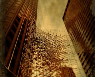 A building with scaffolding, showcasing a vintage look due to the tintype filter