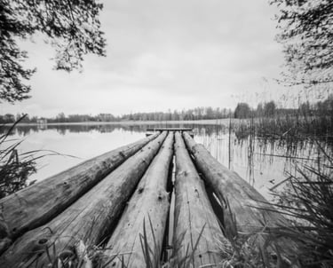 A monochrome image of a wooden dock, showcasing its rustic charm and simplicity