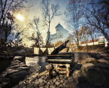 Opened piano standing near the river