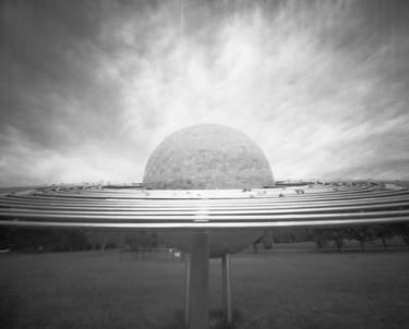 Black and white pinhole picture of a massive orb in the sky.
