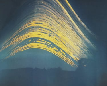 Long exposure captures wave's motion under sun path in blue