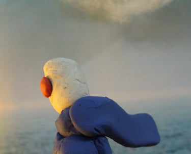 a stuffed animal is sitting on a rock