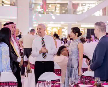 Diverse business professionals networking and laughing at a formal Star Alliance corporate gala event.