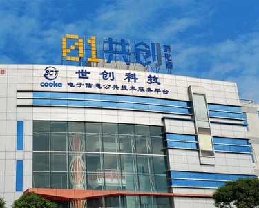 Cooka electronics technology service building with blue glass windows and corporate signage.