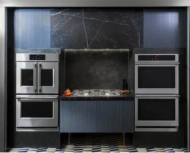 a kitchen with a marbled counter top and a black and white tile floor