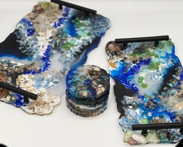 A matching set of two resin trays with black handles and 4 matching scalloped coasters