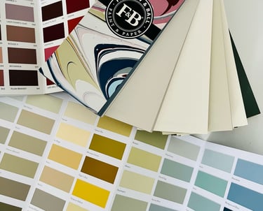 A colour sample book showing different colours and their different shades, spread on a table