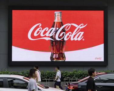 A vibrant display of vertical LED light strips emitting orange and red hues with a warm, glowing effect. The light patterns create a dynamic and colorful visual, resembling a digital or electronic art installation.