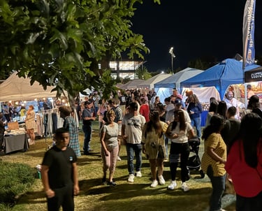 Community crowds filter through artisan booths