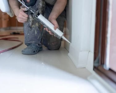 a man in a helmet is fixing a window