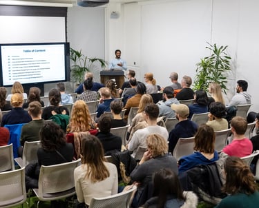 A design professional delivering a talk at a design conference