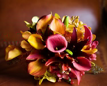 beautiful fall colored bouquet sitting on leather chair