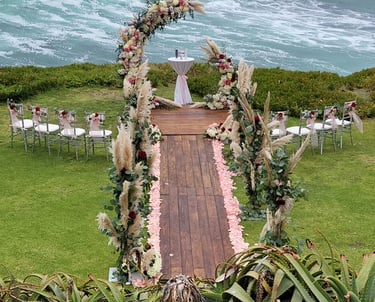 Wedding ceremony at cuvier park-the wedding bowl with custom florals and wooden aisle and platform