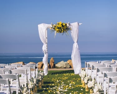 wedding set up at Calumet Park, la jolla, arbor with sheer linens and yellow flowers