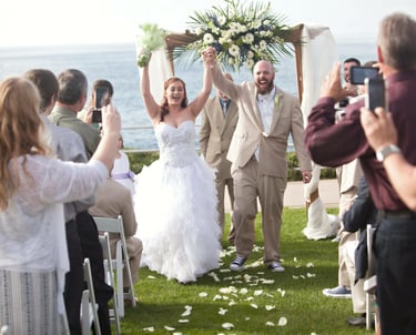 couple celebrating wedding at ellen browning scripps park, la jolla overlooking blue ocean