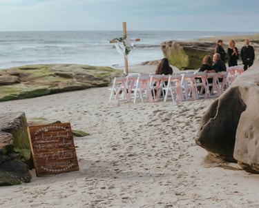 wedding set up on the sand at Windansea Beach la jolla, with cross altar