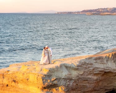 Couple kissing on cliffside bluff at Sunset Cliffs at Osprey Point