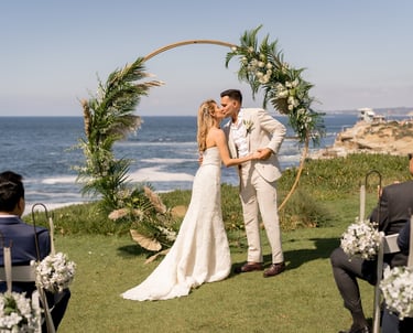 couple kissing in front of a circle wedding arbor at Cuvier Park, the wedding bowl, @sddweddings