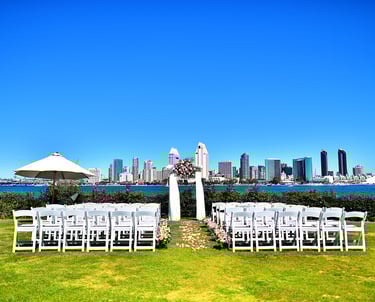 WEdding ceremony set up with floral decorated arbor and pink florals at Centennial Park, Coronado