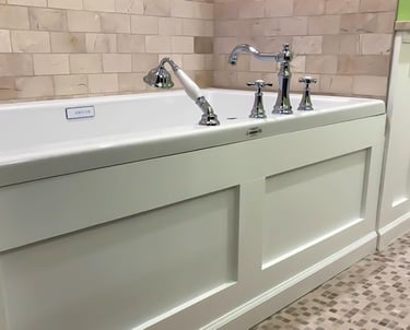a bathtub with wood panels and moldings in the wall
