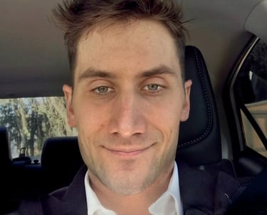 a man in a suit and tie is smiling