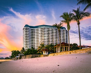 Beachfront resort at sunset with palm trees — UAE hotel deals