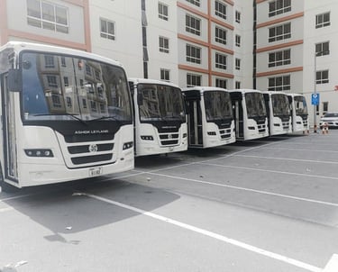 a row of buses parked in a parking lot