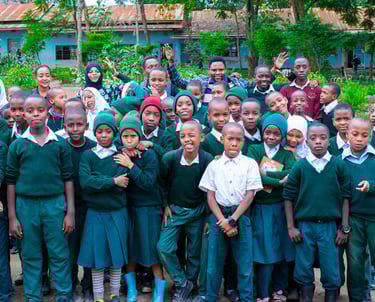 a group of children and adults posing for a group photo