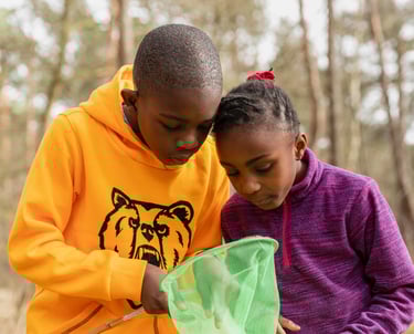 Two children exploring fishing nets