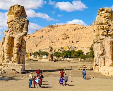 a group of people standing in front of a mountain