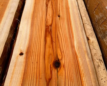 Close-up of natural sugi wood slabs showcasing detailed grain patterns and knots for woodworking.