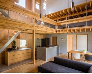 Modern open-concept Japanese house with natural wood framing, mezzanine loft, and industrial kitchen.