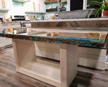 custom dinner table with colored epoxy with gold flecks and reclaimed wood with a maple wood base. Colorado Springs kitchen.