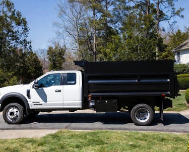 2024 Ford F-550 extended cab with tall JB high side dump bed parked in Fredericksburg Virginia drive