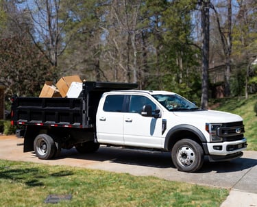 2024 Ford F-550 high side dump truck parked in a clean suburban driveway in Fredericksburg, Virginia