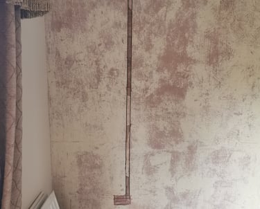 A vertical channel cut into a plastered wall for electrical wire chasing and home renovation.