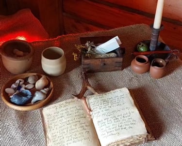 a table with bowls and pots and an old-fashioned handwritten book 