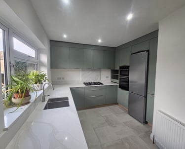 a kitchen with a large window and a potted plant